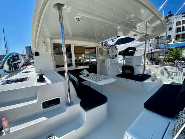 The shaded cockpit with bench seating and a table