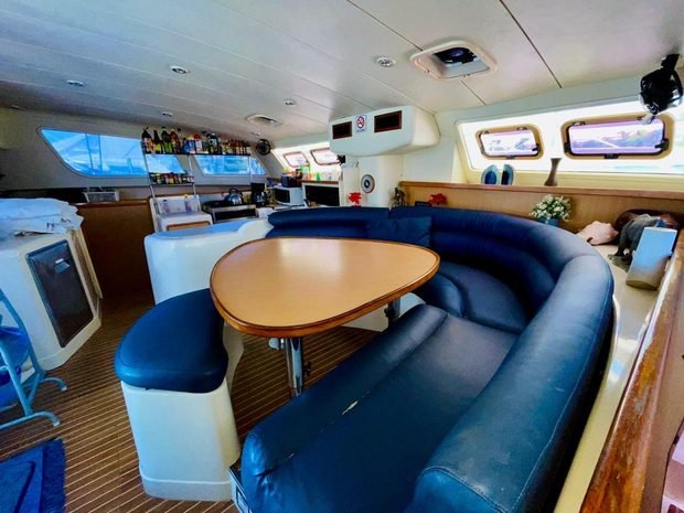 The indoor saloon with wraparound seating, a table and a bar